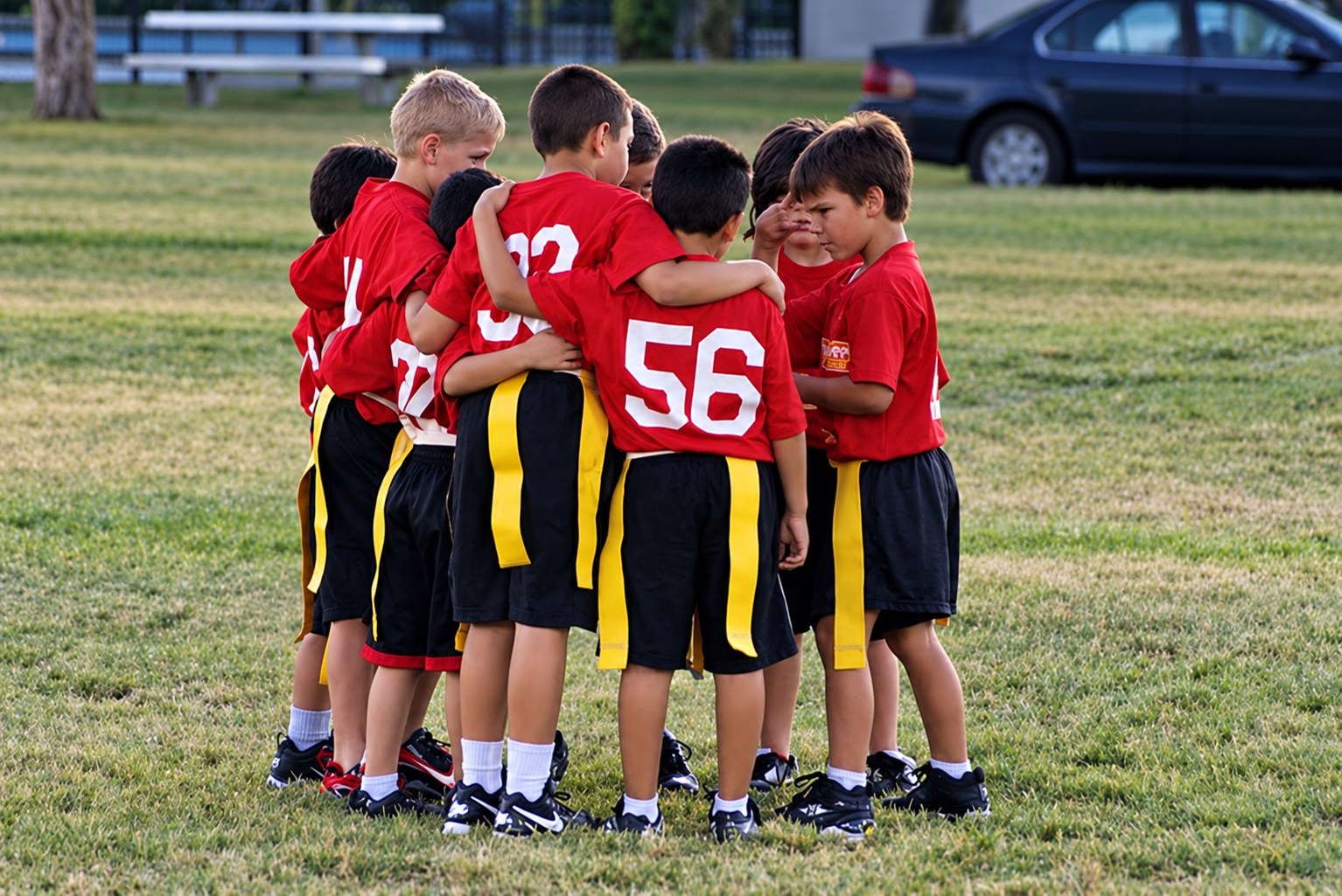 DSA youth flag football teammates huddling